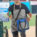 A man holding a Choice blue insulated soft cooler bag.