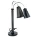 An Eastern Tabletop black double arm heat lamp with metal shades.