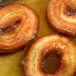 A pan with a group of donuts frying in Zero Trans Fat All Purpose Shortening.