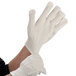A person wearing 9 13/16" heat-resistant gloves.