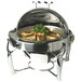 A Vollrath stainless steel round chafer with food inside.
