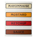 A San Jamar condiment bar with labels for different condiments.