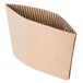 A natural Kraft corrugated cardboard coffee cup sleeve with a fold.