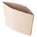 A brown corrugated cardboard coffee cup sleeve with a strip of paper.