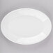 A white Homer Laughlin oval china platter with a white rim on a gray surface.