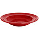 A red Tuxton Concentrix china bowl with a circular rim.