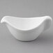 A Tuxton white china gravy boat with a handle.