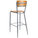 A Lancaster Table & Seating metal cafe bar stool with a wooden seat and backrest.