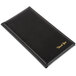 A black leather Menu Solutions guest check presenter with gold writing on it.