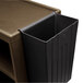 A black plastic bin on a brown surface.