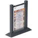 A Menu Solutions ash wood flip top table tent holding a menu on a table.