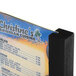 A black wooden Menu Solutions table tent holding a menu on a counter.