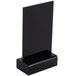 A black rectangular Menu Solutions wet erase table sign board with a black wood base.