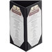 A Menu Solutions table tent with white and black picture corners holding a menu card.
