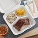 An EcoChoice compostable takeout container holding ribs and coleslaw.