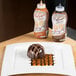 A chocolate dessert on a plate with Smucker's Chocolate Platescapers syrup drizzled on top.