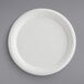 A close-up of an EcoChoice Compostable Sugarcane Bagasse plate with a white rim.