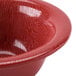 A close up of a red GET Etchedware textured bowl.