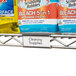 A shelf with a product label holder holding a label for cleaning supplies.