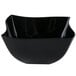 A black Fineline Wavetrends plastic bowl with a curved edge.
