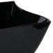 A black Fineline plastic bowl with a curved edge.