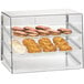 A Cal-Mil classic three tier glass pastry display case full of pastries on a bakery counter.