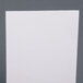 A white paper on a gray surface.