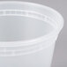 A close-up of a Pactiv translucent plastic deli container with a curved edge.