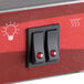 A close-up of the red and black switch on an Avantco Freestanding French Fry Warmer.