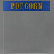 Clear glass side for a Paragon popcorn popper with blue and yellow text that says "popcorn"