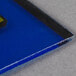 A blue square glass panel with yellow square design.