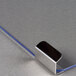 A close-up of a blue and silver metal clip for a Paragon popcorn popper door.