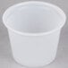 A translucent Solo polystyrene souffle cup on a grey surface.