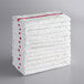 A stack of white Choice bar towels with red stripes.