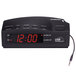 A black Conair digital alarm clock with red numbers.