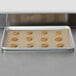 A Bagcraft Packaging parchment paper pan liner with a tray of cookies on it.