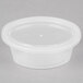 A clear Newspring oval plastic souffle container with a lid.