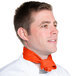 A man wearing an orange Intedge chef neckerchief around his neck.