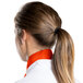 A woman wearing an orange Intedge chef neckerchief with a ponytail.