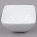 An Arcoroc white square bowl.