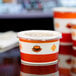 A close-up of a Choice paper soup cup with a vented plastic lid.