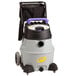A grey and black ProTeam wet vacuum with a purple handle on a cart.