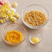A bowl of yellow popcorn kernels.