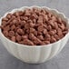 A bowl of HERSHEY'S Milk Chocolate 1M Baking Chips.