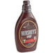 A bottle of HERSHEY'S Special Dark Chocolate Syrup on a store counter.