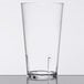 A clear GET plastic mixing glass with a clear liquid inside.