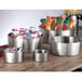 An American Metalcraft stainless steel double wall bowl on a table filled with packets.