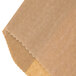 A brown paper bag with a piece of paper inside.