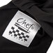 A close up of a black Chef Revival cloth with a black and white label.