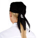 A woman wearing a black Chef Revival head wrap.